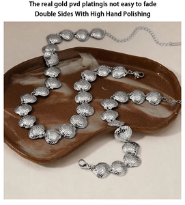 Detailed view of silver shell texture necklace with polished PVD plating and clasp