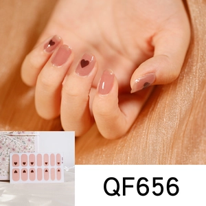 Detail view of purple heart cow pattern nail stickers QF656 on a hand with packaging