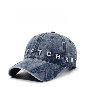 Detailed embroidery and vintage distressed stars on a navy blue washed denim baseball cap