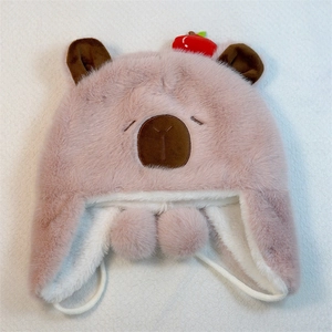 Detailed top view of pink plush bear trapper hat with warm earflaps and pompom ties