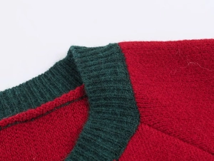 Close-up of red and green knit sweater showing collar detail and ribbed texture
