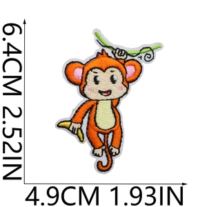 Detailed embroidery patch of a cartoon monkey holding a banana with size measurements