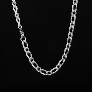 Macro shot of silver metal textured oval link necklace for men over a black background
