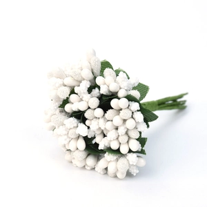 Macro detail of white frosted berry artificial stamens with green leaves for DIY crafts