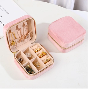 Pink velvet jewelry box detail showing interior necklace hooks and ring slots