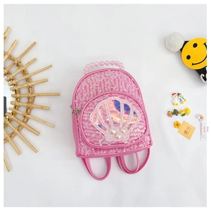 Detailed view of kids shell sequin backpack with pink beads handle and pearl accents
