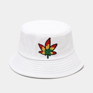 Macro detail of white bucket hat with colorful leaf embroidery and reinforced brim stitching