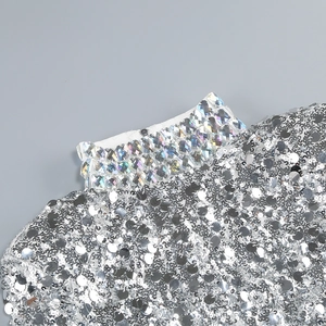 Detailed close-up of high neck collar with rhinestones and silver sequins on elegant dress