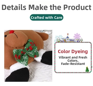 Detail of Christmas reindeer plush toy with green bow tie and soft brown fabric texture