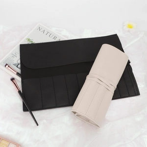 Portable PU leather makeup brush roll in black and beige with litchi grain texture