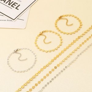 Detail view of gold and silver stainless steel disc chain jewelry set components