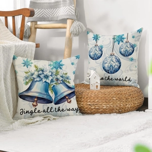 Close-up of linen Christmas cushion covers with Jingle all the way blue lettering