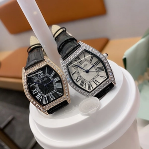 Close-up of luxury tonneau watches with diamond bezel and leather strap details