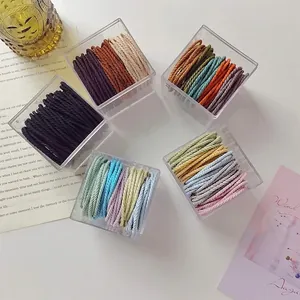 Elastic striped hair ties set in clear boxes with colorful macaron spiral designs