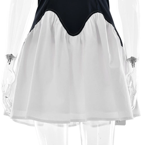 Detail of waist stitching and pleated black and white contrast dress hem on mannequin