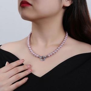 Elegant pink pearl necklace for women featuring a polished silver circular pendant clasp