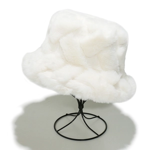 Close-up of white faux fur fisherman hat showing thick woven plush texture and warmth