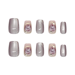 Handmade purple cat eye press-on nails with silver glitter bow and rhinestones