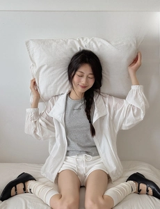 Detail of soft cotton JK style thin jacket paired with casual white sports shorts