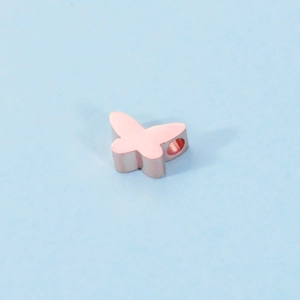 Macro shot of rose gold butterfly bead connector with a side hole for DIY jewelry