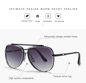 Detail view of double-bridge aviator sunglasses with purple gradient lenses and metal frame