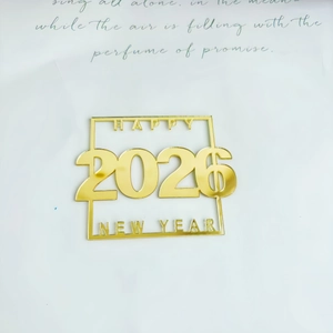 Macro shot of mirror gold acrylic Happy 2026 New Year cupcake topper decoration