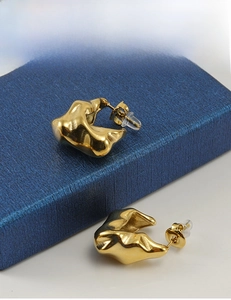 Macro view of 18K gold plated irregular geometric earrings with fluid metal texture