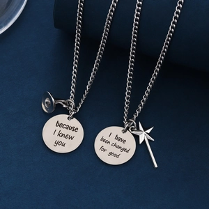 Stainless steel friendship necklaces with engraved pendants on a premium blue background