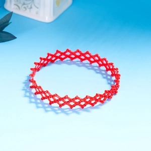 Detail view of red telescopic hair ring with bird nest structure and red resin accents