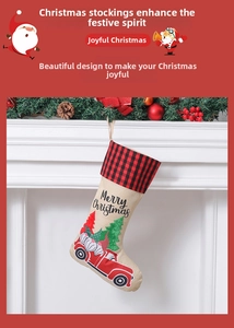 Macro detail of burlap Christmas stocking featuring a red truck and gnome embroidery
