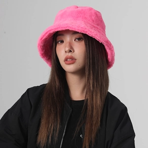 Detail of plush faux rabbit fur texture on a warm neon pink winter bucket hat
