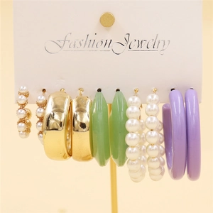 Detail of 5-piece earring set with gold finish, pearls and colorful resin on a display card