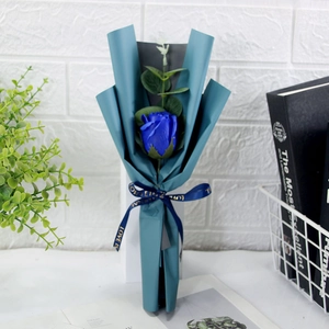 Detail of blue soap rose flower bouquet with eucalyptus leaves and printed ribbon