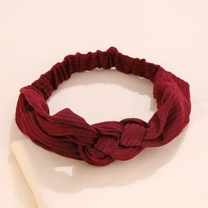 Detailed view of the burgundy ribbed knit fabric texture on the knotted wide headband