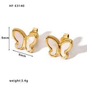 Macro shot of 18K gold plated butterfly studs with white shell inlay, size 9x9mm