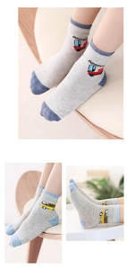 Detail of grey knitted cotton baby socks featuring colorful cartoon bus patterns