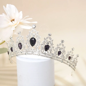 Macro detail of luxury crown with purple teardrop gems and sparkling white rhinestones