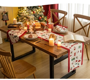 Close-up of Christmas table runner with snowman patterns and festive Merry Christmas text