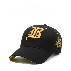 Close-up of golden gothic B embroidery on a premium black cotton baseball cap