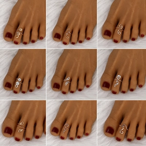 Set of 9 gold and silver geometric toe rings in spiral, heart and wave designs