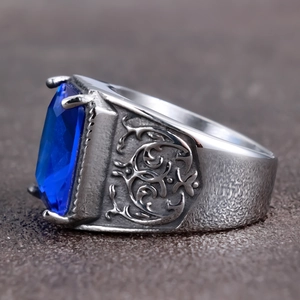Men's vintage stainless steel ring featuring a blue rectangular gemstone with carvings