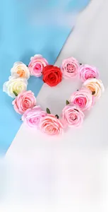 Detailed arrangement of assorted faux silk rose heads in heart-shaped layout