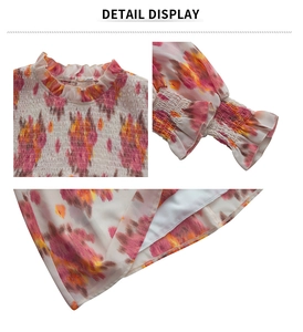 Detail display of floral chiffon top with ruffled neckline and elastic smocked cuffs