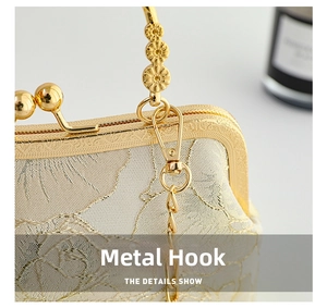 Macro detail of golden floral jacquard fabric and carved metal frame with floral hook