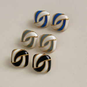 Three pairs of square enamel stud earrings in blue grey and black with gold edges