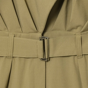Close-up of olive green sleeveless jumpsuit waist with matching belt and metal buckle