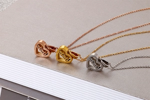 Detailed view of heart-shaped mama pendant necklaces in gold, silver, and rose gold