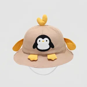 Dettaglio di un cappello da sole per neonati con ricamo pinguino e decori 3D gialli