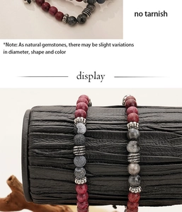 Macro detail of natural stone beaded bracelet with red, grey, and matte black gemstones