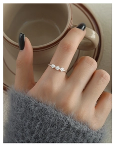 Close-up of s925 silver ring featuring three delicate plum blossoms on woman's finger